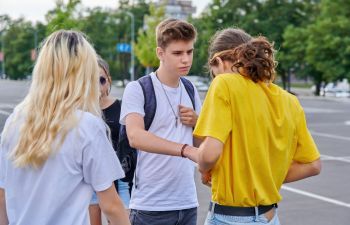 Group of teens hanging round a city.